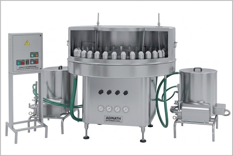 Industrial stainless steel rotary bottling machine with multiple fill heads and control panel on the left, connected by hoses to ancillary tanks.