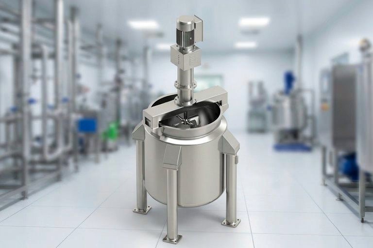 High-shear stainless steel industrial mixer in a clean laboratory/production room.