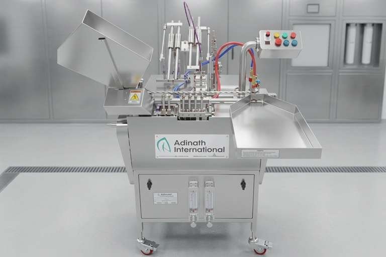 Stainless steel industrial processing machine with tubing and a control panel in a clean laboratory, labeled Adinath International.