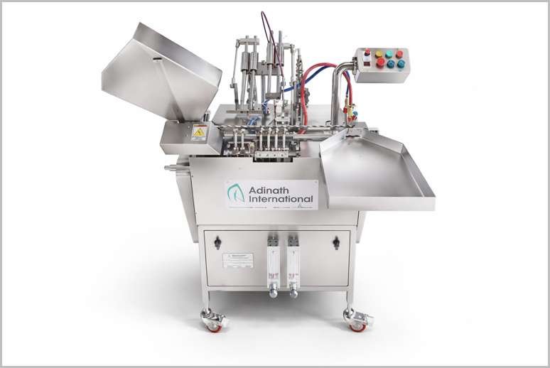 Stainless steel pharmaceutical filling machine with hopper, pistons, and control panel on wheels (Adinath International)