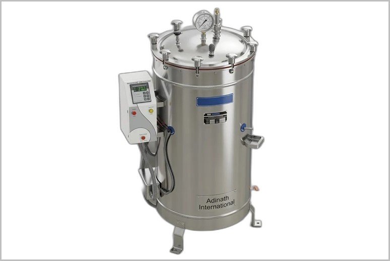 Stainless steel laboratory autoclave with top pressure gauge and control panel on the left side.