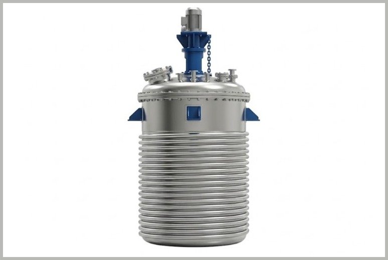 Industrial stainless steel vertical pressure vessel with blue fittings and motor on top, likely a reactor or storage tank used in processing.