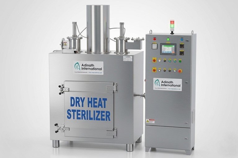 Industrial dry heat sterilizer with stainless steel chamber and adjacent control cabinet labeled Adinath International, used for high-temperature sterilization.