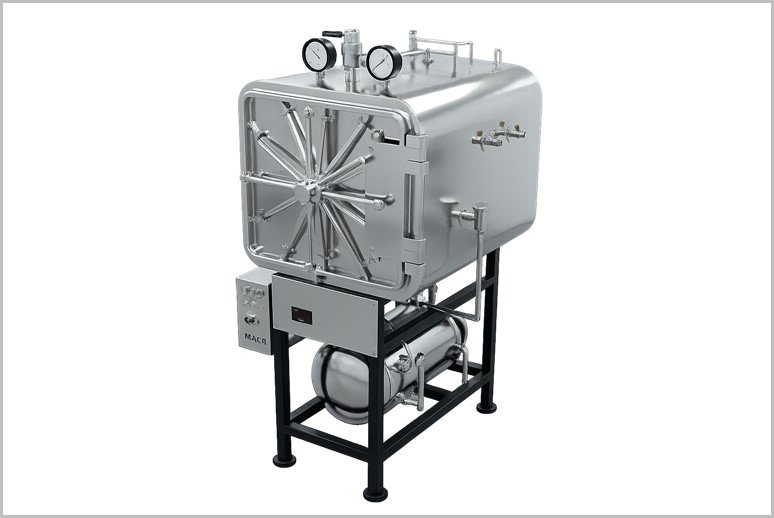 Industrial stainless steel autoclave on a black metal frame with gauges on top and a large circular door front.