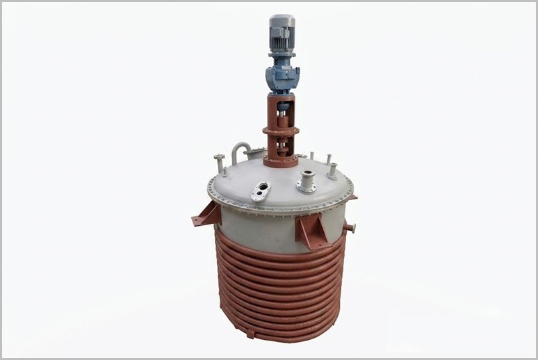 Vertical industrial reactor with red spiral cooling coil and a blue motor on top