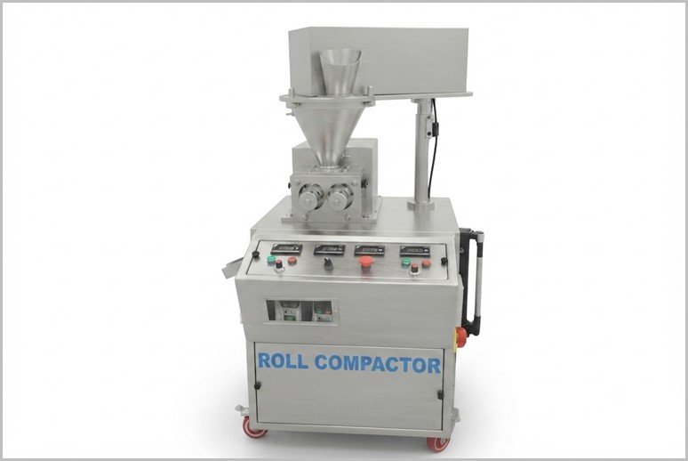 Roll compactor machine on wheels with hopper and control panel, labeled 'ROLL COMPACTOR' on the front panel